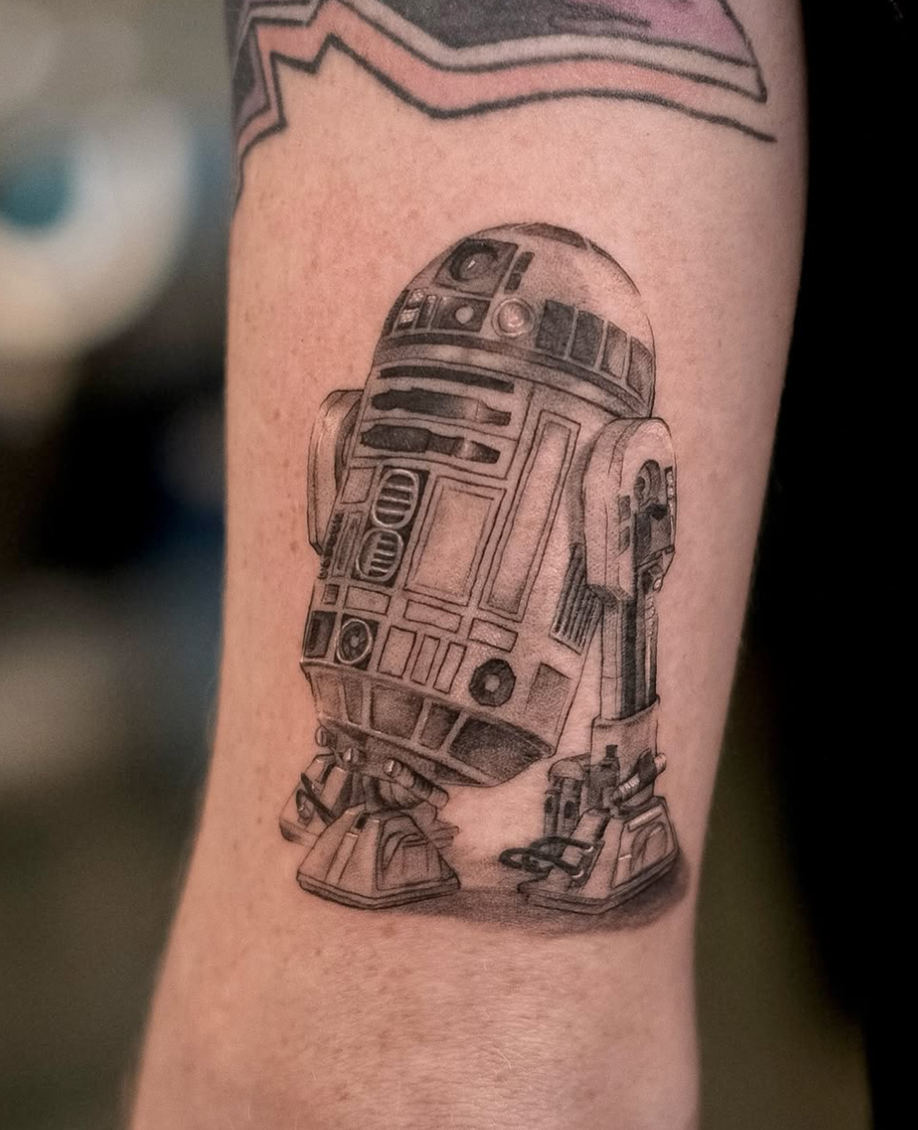realistic illustrative black and grey tattoo of R2D2
